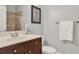 Clean bathroom with a wooden vanity, white countertop, and a shower with a glass door at 1583 Mosaic Way, Smyrna, GA 30080