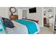 Bedroom with connecting bathroom features a mounted TV at 1583 Mosaic Way, Smyrna, GA 30080