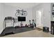 Home gym with a treadmill, stationary bike, wall-mounted bike, and fitness equipment for a healthy lifestyle at 1583 Mosaic Way, Smyrna, GA 30080