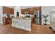 Open kitchen with granite counters, stainless steel appliances and seating at island at 1583 Mosaic Way, Smyrna, GA 30080