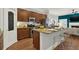 Spacious kitchen island featuring granite countertops, wooden cabinets, and modern stainless steel appliances at 1583 Mosaic Way, Smyrna, GA 30080
