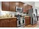 Well-equipped kitchen featuring granite countertops, stainless steel appliances, and wooden cabinets at 1583 Mosaic Way, Smyrna, GA 30080