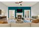 Bright living room with fireplace, french doors, hardwood floors, and a comfortable seating area at 1583 Mosaic Way, Smyrna, GA 30080