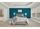 Bright main bedroom features a large window, teal accent wall, and tray ceiling detail at 1583 Mosaic Way, Smyrna, GA 30080