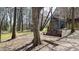 Serene park view with a cozy swing bench and play structure surrounded by tall trees and natural landscaping at 1583 Mosaic Way, Smyrna, GA 30080