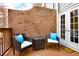 Cozy outdoor patio area features comfortable seating and a brick privacy wall at 1583 Mosaic Way, Smyrna, GA 30080
