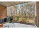Relaxing brick patio with a black metal fence, offering privacy and a view of the wooded area at 1583 Mosaic Way, Smyrna, GA 30080