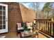 Relaxing patio area with comfortable seating, privacy wall, and views of the surrounding landscape at 1583 Mosaic Way, Smyrna, GA 30080