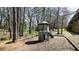 Well-equipped community playground with climbing features, slide, and swing set nestled in a wooded area at 1583 Mosaic Way, Smyrna, GA 30080