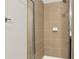 Neat tiled shower with sleek glass doors and modern fixtures, showcasing a clean and functional space at 1583 Mosaic Way, Smyrna, GA 30080