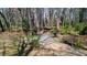 Picturesque walking trail with a wooden bridge and bench seating, surrounded by lush greenery and mature trees at 1583 Mosaic Way, Smyrna, GA 30080
