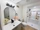 Modern bathroom with a sleek vanity, framed mirror, and a shower with built-in shelving at 2371 Cresta Dr, Decatur, GA 30032