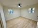 Clean bedroom with light wood floors and bright natural light from windows overlooking outdoor space at 2371 Cresta Dr, Decatur, GA 30032
