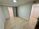 Bright bedroom featuring light wood floors and neutral walls, illuminated by a ceiling light at 2371 Cresta Dr, Decatur, GA 30032