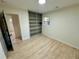 Bright bedroom featuring hardwood floors, a built-in bookshelf, and a large window offering natural light at 2371 Cresta Dr, Decatur, GA 30032