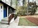 Side view of the home's entrance, showing the manicured lawn and a bright blue front door at 2371 Cresta Dr, Decatur, GA 30032