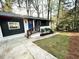 Charming home with a freshly painted exterior, manicured lawn, and a bright blue front door at 2371 Cresta Dr, Decatur, GA 30032