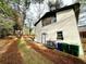 Side view of a home, showing the white painted brick, a back door, and a grassy side yard at 2371 Cresta Dr, Decatur, GA 30032