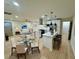 Open-concept living space with modern kitchen, white cabinets, island, stainless steel appliances, and dining area at 2371 Cresta Dr, Decatur, GA 30032