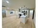 Open-concept kitchen with modern white cabinets, stainless steel appliances, and hardwood floors at 2371 Cresta Dr, Decatur, GA 30032