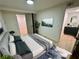 Comfortable bedroom with a calming view, featuring a full bed, dresser, and doorway into another room at 2371 Cresta Dr, Decatur, GA 30032