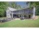 Spacious backyard with deck, patio seating, fire pit, and hot tub surrounded by mature trees at 281 Laney Dr, Locust Grove, GA 30248
