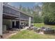 Backyard featuring a large patio with seating, fire pit, and a hot tub under a spacious deck at 281 Laney Dr, Locust Grove, GA 30248