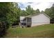 Expansive backyard featuring a two-story deck, patio, fire pit, and lush greenery at 281 Laney Dr, Locust Grove, GA 30248