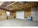 Spacious unfinished basement with garage door, rough insulation and concrete floor offering versatility and customization options at 281 Laney Dr, Locust Grove, GA 30248