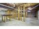 Unfinished basement featuring wooden framing, concrete floor, and exposed ceiling at 281 Laney Dr, Locust Grove, GA 30248