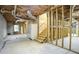 Spacious unfinished basement with wooden framing, exposed ceiling, and stairs to customize at 281 Laney Dr, Locust Grove, GA 30248