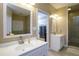 Open-concept bathroom featuring double sinks and a walk-in shower at 281 Laney Dr, Locust Grove, GA 30248