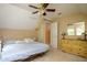 Large upstairs bedroom with vaulted ceilings, a bed, and a wooden dresser with decor at 281 Laney Dr, Locust Grove, GA 30248