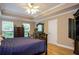 Comfortable bedroom with hardwood floors, large windows, and a spacious dresser at 281 Laney Dr, Locust Grove, GA 30248