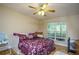 Bedroom features a queen size bed, ceiling fan, and plenty of natural light from the window at 281 Laney Dr, Locust Grove, GA 30248