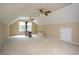 This spacious bonus room has carpeted floors, two ceiling fans, and ample natural light at 281 Laney Dr, Locust Grove, GA 30248