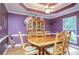 Elegant dining room with hardwood floors, hutch, and decorative tray ceiling at 281 Laney Dr, Locust Grove, GA 30248