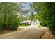Beautifully landscaped single-story home with two-car garage and basketball hoop at 281 Laney Dr, Locust Grove, GA 30248