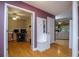 Hallway featuring hardwood floors, coat rack, doorway views of a study and living room, and natural light at 281 Laney Dr, Locust Grove, GA 30248