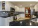 Bright kitchen with stainless steel appliances, black countertops, and herringbone tile backsplash at 281 Laney Dr, Locust Grove, GA 30248