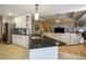 Kitchen featuring island with white cabinets, dark countertops and access to living room at 281 Laney Dr, Locust Grove, GA 30248
