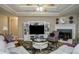 Open living room area with large TV, fireplace and coffered ceilings at 281 Laney Dr, Locust Grove, GA 30248