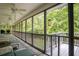 Large screened porch featuring views of the forest, ceiling fans, and plenty of seating, perfect for outdoor living at 281 Laney Dr, Locust Grove, GA 30248