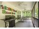 Inviting screened porch with ceiling fans, dining table and chairs, and a grill for outdoor enjoyment at 281 Laney Dr, Locust Grove, GA 30248