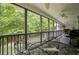Spacious screened porch with views of surrounding trees, dining table, and comfortable outdoor seating at 281 Laney Dr, Locust Grove, GA 30248