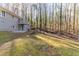 Spacious backyard features mature trees and a two-story home with a deck and walkout basement at 5845 Highway 92, Fairburn, GA 30213