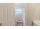 A bright bathroom boasting a white vanity, wood-style floor, and a window at 5845 Highway 92, Fairburn, GA 30213