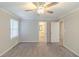 A serene bedroom featuring neutral walls, plush carpeting, and a ceiling fan for added comfort at 5845 Highway 92, Fairburn, GA 30213