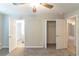 Carpeted bedroom featuring ceiling fan, and two open doors with closets at 5845 Highway 92, Fairburn, GA 30213