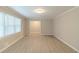 Bright living room featuring large window, neutral walls, and light wood-look flooring at 5845 Highway 92, Fairburn, GA 30213